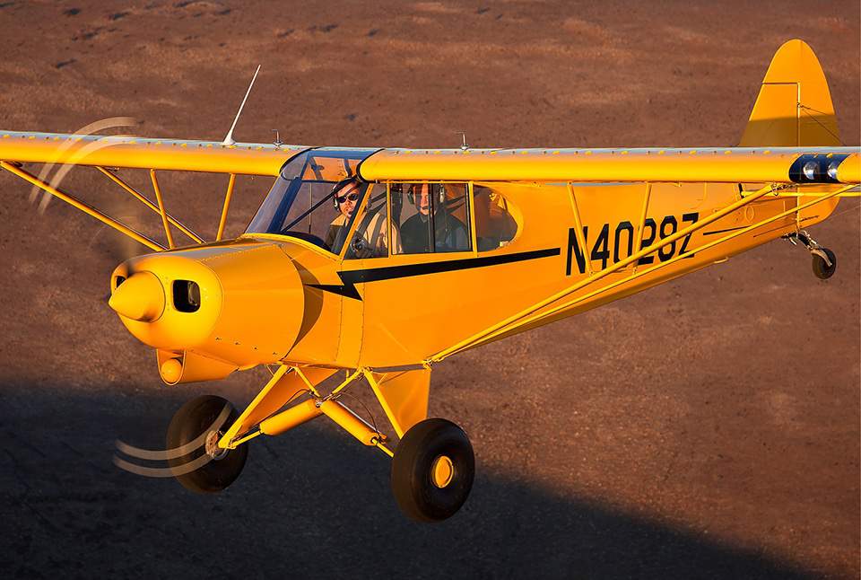 Yellow Lightning Bolt Super Cub in flight